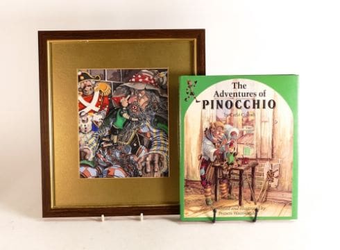 A copy of The Adventures of Pinocchio alongside a framed piece of original artwork by illustrator Francis Wainwright