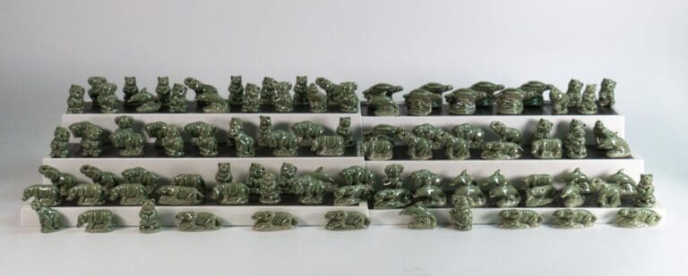 A large collection of green glazed Wade Whimsies protoypes