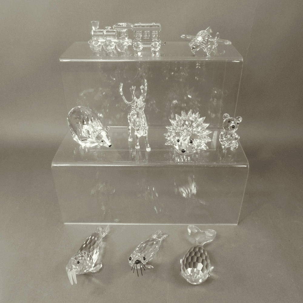 A mixed collection of Swarovski Crystal Animal figures and ornaments to include a Locomotive, Aeroplane, Polar Bear, Reindeer, Walrus, Hedgehog, Bear, Beaver etc 11 in total (1 tray) All in original boxes