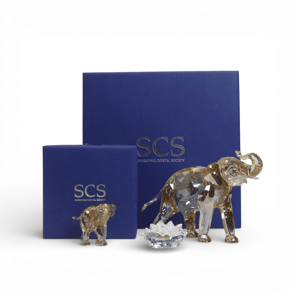 Swarovski Cinta Elephant (1137207) with Cinta Plaque together with young Elephant Calf (1142862) both retired 2013 designed by Elisabeth Adamer presented in Light Sand Crystal. Tallest:-11cm. Boxed Cinta certificate of authenticity (3)